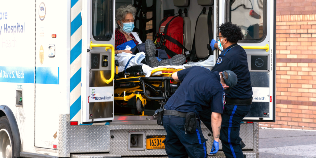 A COVID-19 patient in an ambulance with two emergency technicians