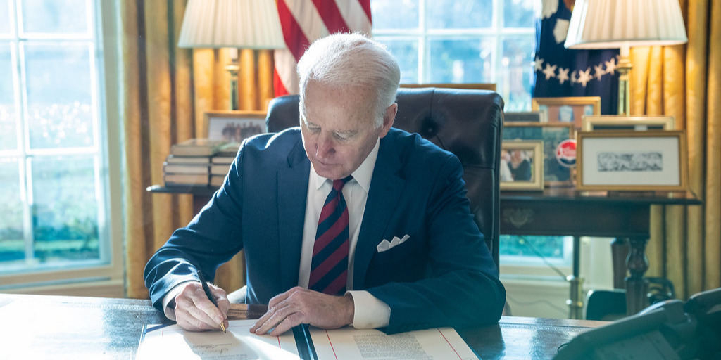 President Biden signing legislation in the Oval Office