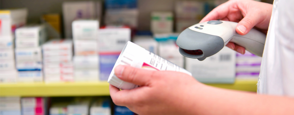 a pharmacist scanning a barcode on a pill bottle