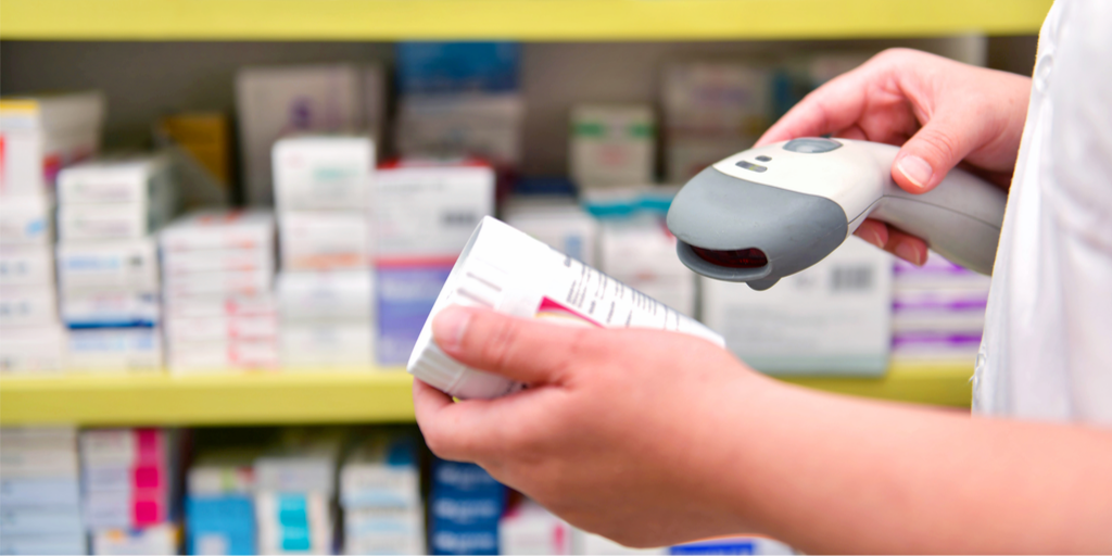 a pharmacist scanning a barcode on a pill bottle