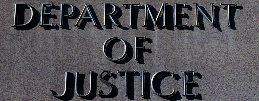 Department of Justice sign on a building facade