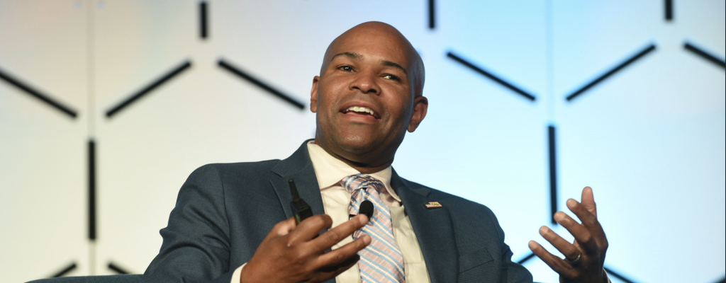 Former U.S. Surgeon General Jerome Adams speaking at a conference