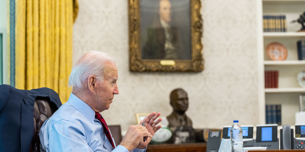 President Joe Biden seated in the Oval Office