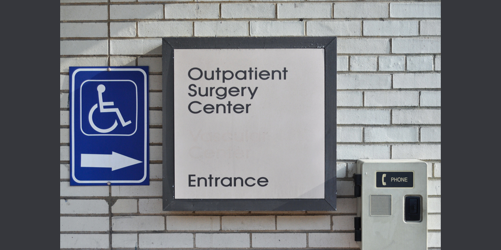 outpatient surgery center entrance sign on building facade