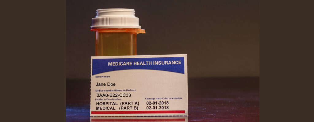 pill bottle and Medicare health insurance card