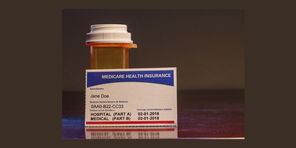 pill bottle and Medicare health insurance card