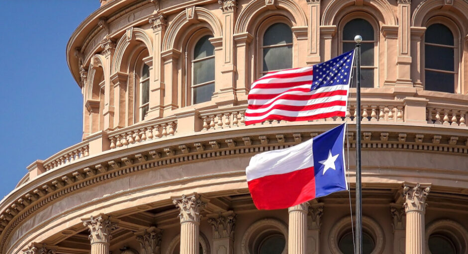 Texas state capitol building with United States and Texas state flags