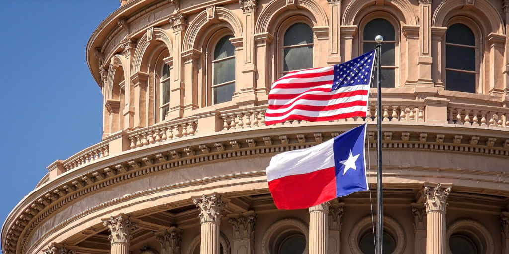 Texas state capitol building with United States and Texas state flags